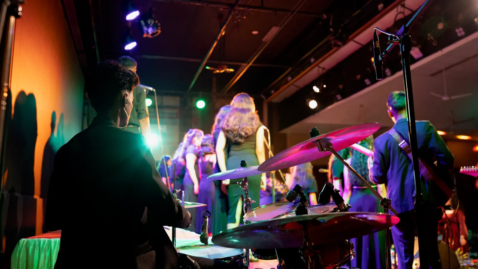 Full band on a colourful stage