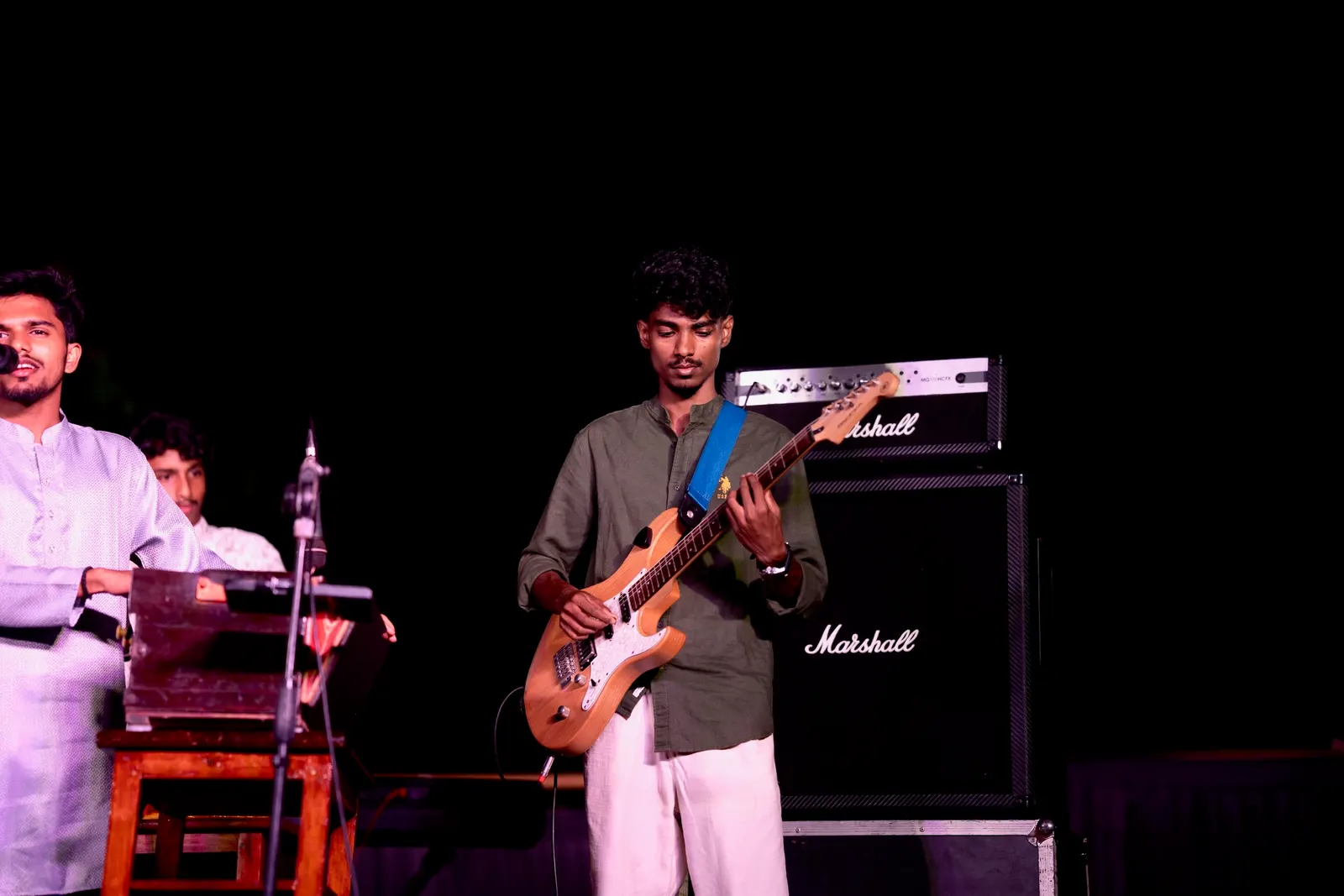 Guitarist beside a Marshall stack