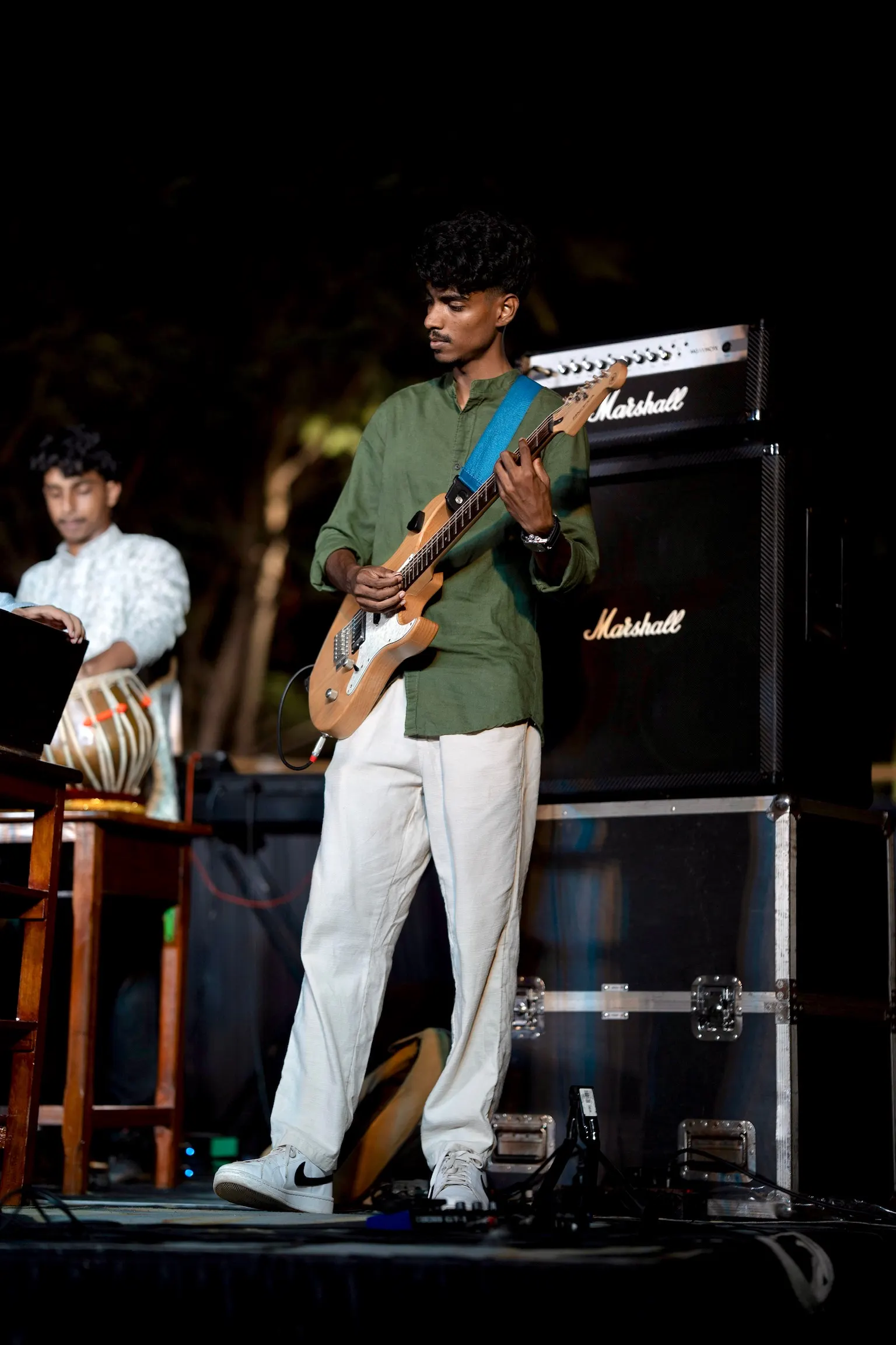 On stage with a blue guitar