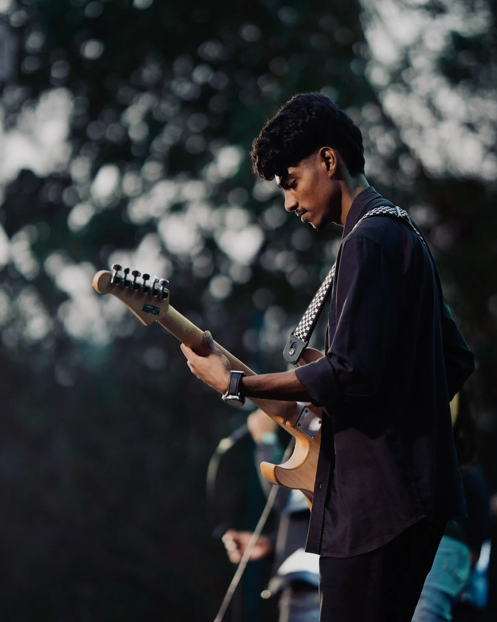 Ephraim playing guitar outdoors