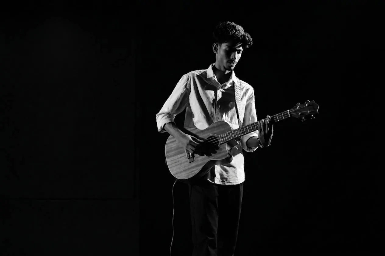 Performing with guitar under stage lights